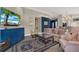 Inviting living room featuring stylish furniture, a vibrant blue accent wall, and unique tile flooring at 500 Westborough Ln, Safety Harbor, FL 34695