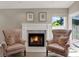 Cozy living space features a fireplace flanked by patterned chairs, with natural light from a nearby window at 500 Westborough Ln, Safety Harbor, FL 34695