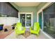Relaxing screened patio area featuring two bright green Adirondack chairs and access to the pool at 500 Westborough Ln, Safety Harbor, FL 34695