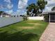 Green grass in the backyard with a privacy fence provides a secure space for outdoor activities and pets at 5201 Denver Ne St, St Petersburg, FL 33703