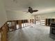 Spacious living room awaiting renovation, featuring a ceiling fan and ample natural light at 5201 Denver Ne St, St Petersburg, FL 33703