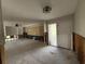 Living room needing renovation, features original built-ins, light, and large sliding glass doors at 5201 Denver Ne St, St Petersburg, FL 33703