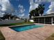 Sparkling pool with brick patio, perfect for outdoor entertaining and relaxation in a serene backyard setting at 5201 Denver Ne St, St Petersburg, FL 33703