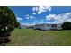 Exterior shot of the home featuring a spacious backyard perfect for outdoor activities and relaxation at 5318 Mary St, Zephyrhills, FL 33542