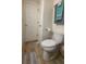 Bathroom featuring a toilet, tile floors, and convenient storage at 5318 Mary St, Zephyrhills, FL 33542