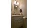 Bathroom featuring tiled backsplash, light walls, and a modern sink at 5318 Mary St, Zephyrhills, FL 33542