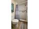 Bathroom featuring a shower with tiled surround and a striped shower curtain at 5318 Mary St, Zephyrhills, FL 33542