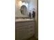 Bathroom vanity with neutral countertop, decorative backsplash, and ample storage at 5318 Mary St, Zephyrhills, FL 33542