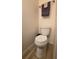 Compact bathroom featuring a white toilet and light walls at 5318 Mary St, Zephyrhills, FL 33542
