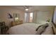 Brightly lit bedroom with ceiling fan, ensuite bathroom, light walls, and hardwood-look flooring at 5318 Mary St, Zephyrhills, FL 33542