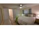 Bedroom with light walls, wood-look flooring, ceiling fan, and ensuite bathroom at 5318 Mary St, Zephyrhills, FL 33542