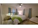 Cozy bedroom with ceiling fan, light walls, light wood-look floors, and bright natural light at 5318 Mary St, Zephyrhills, FL 33542