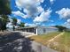 View of the clubhouse with ample parking and an American flag on a sunny day at 5318 Mary St, Zephyrhills, FL 33542