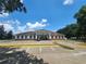 Well-maintained community clubhouse featuring ample parking, manicured landscaping, and a welcoming facade under a sunny sky at 5318 Mary St, Zephyrhills, FL 33542