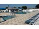 Community pool featuring lounge chairs, tables, and a building at 5318 Mary St, Zephyrhills, FL 33542