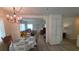 Bright dining room with elegant chandelier and seamless access to the living area at 5318 Mary St, Zephyrhills, FL 33542
