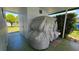 Exterior view of a home with covered porch and shrouded outdoor item at 5318 Mary St, Zephyrhills, FL 33542