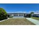 Charming single-story home with a covered carport and awning-shaded windows, surrounded by a well-maintained yard at 5318 Mary St, Zephyrhills, FL 33542