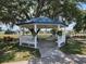 Community gazebo featuring a white picket fence and lovely landscaping at 5318 Mary St, Zephyrhills, FL 33542