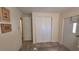 Bright hallway with wood-look floors, closet, and white doors at 5318 Mary St, Zephyrhills, FL 33542