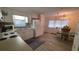 Bright kitchen featuring white cabinets, stainless steel sink, and adjacent dining area at 5318 Mary St, Zephyrhills, FL 33542