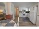 Modern white kitchen with updated backsplash and stainless appliances near the living area at 5318 Mary St, Zephyrhills, FL 33542