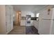 Updated kitchen with white cabinetry, wood-look flooring, and neutral backsplash at 5318 Mary St, Zephyrhills, FL 33542