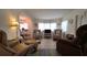 Comfortable living area with natural light, accent chairs, and wood-look flooring at 5318 Mary St, Zephyrhills, FL 33542