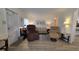 Cozy living room with recliner chairs, decorative art, and wood-look flooring at 5318 Mary St, Zephyrhills, FL 33542