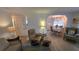 Cozy living room flows into a dining area, featuring neutral decor and wood-look flooring at 5318 Mary St, Zephyrhills, FL 33542