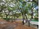 Picturesque park featuring mature oak trees, benches, and well-maintained green space for community enjoyment at 5318 Mary St, Zephyrhills, FL 33542