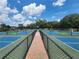 Enjoy the community's pickleball courts with blue and green surfaces, separated by black fencing, for outdoor fun and recreation at 5318 Mary St, Zephyrhills, FL 33542
