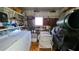 Utility shed interior featuring laundry appliances, shelving and other household items at 5318 Mary St, Zephyrhills, FL 33542