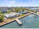 Expansive waterfront home features a private dock with boat lift and stunning water access from an aerial perspective at 5409 Pali Way, St Pete Beach, FL 33706