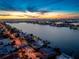 Picturesque waterfront community at dusk, with glowing city lights reflecting on the tranquil waters, as seen from above at 5409 Pali Way, St Pete Beach, FL 33706
