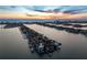 Expansive aerial view captures a waterfront community at sunset, showcasing stunning oceanfront property with pools and private docks at 5409 Pali Way, St Pete Beach, FL 33706