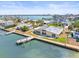 Waterfront property features a private dock, lush landscaping, and expansive water views from an aerial perspective at 5409 Pali Way, St Pete Beach, FL 33706