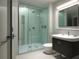 Contemporary bathroom featuring a glass-enclosed shower, modern vanity, and neutral color palette at 5409 Pali Way, St Pete Beach, FL 33706