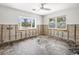 Bedroom being renovated with bay window, windows, and ceiling fan at 5409 Pali Way, St Pete Beach, FL 33706