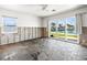 Unfinished bedroom features a large sliding glass door with water views, ready for renovation and customization at 5409 Pali Way, St Pete Beach, FL 33706