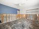 Stripped bedroom ready for renovation with blue accent wall and ceiling fan at 5409 Pali Way, St Pete Beach, FL 33706