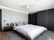 A modern bedroom with sleek, minimalist design, featuring white walls and luxury bedding with a ceiling fan at 5409 Pali Way, St Pete Beach, FL 33706
