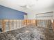 Bedroom undergoing renovation with exposed studs and flooring, contrasted by a blue accent wall at 5409 Pali Way, St Pete Beach, FL 33706