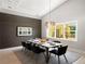 Elegant dining room featuring modern chandelier, large window, and sleek design, perfect for entertaining guests at 5409 Pali Way, St Pete Beach, FL 33706