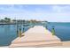 Wooden dock with sturdy pilings offers direct access to the sparkling waterfront, perfect for boating and relaxation at 5409 Pali Way, St Pete Beach, FL 33706