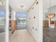 Entryway offering a glimpse into the home's potential with water views, an elegant chandelier, and tiling at 5409 Pali Way, St Pete Beach, FL 33706