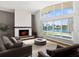 Bright living room boasts fireplace, large windows with water views, and a comfortable seating arrangement at 5409 Pali Way, St Pete Beach, FL 33706