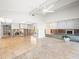 Spacious room showcasing renovation with exposed studs and tile-to-plywood flooring transition at 5409 Pali Way, St Pete Beach, FL 33706