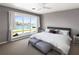 Bright, modern bedroom with waterfront views from a large window, enhancing the serene ambiance at 5409 Pali Way, St Pete Beach, FL 33706