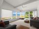 Bright sunroom with water views, comfortable seating, and large windows at 5409 Pali Way, St Pete Beach, FL 33706